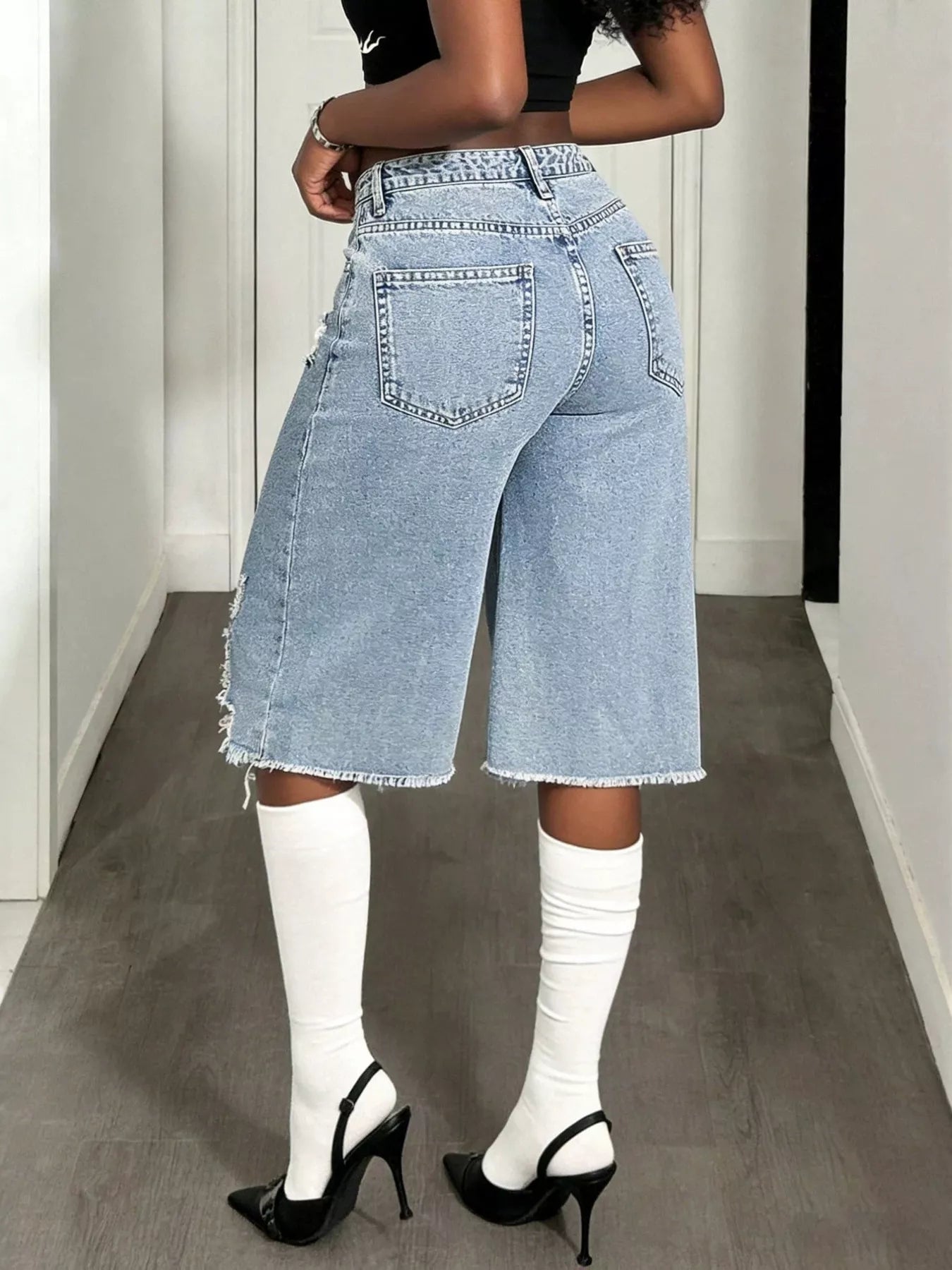 Distressed wide-leg denim shorts by Plush Fashion Hub with frayed edges and casual fit, displayed on a neutral background.