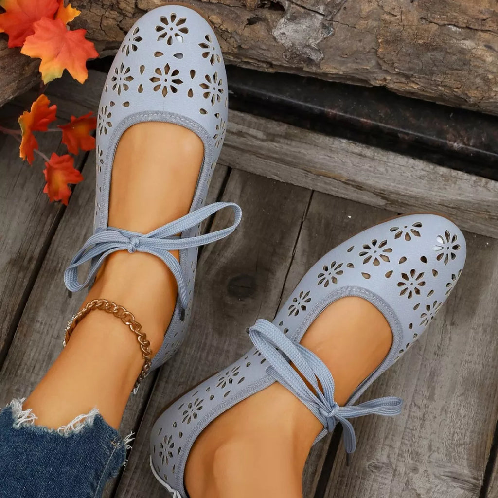 Plush Fashion Hub floral cutout tied slip-on sandals with open toe design and decorative flower accents on a neutral background.