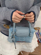 Denim handbag with embroidered puppy design, stylish accessory from Shopimist featuring detailed stitching and casual chic style.