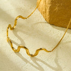 18K gold-plated wave necklace with sleek, flowing design, featuring a shiny, polished surface and elegant chain display.