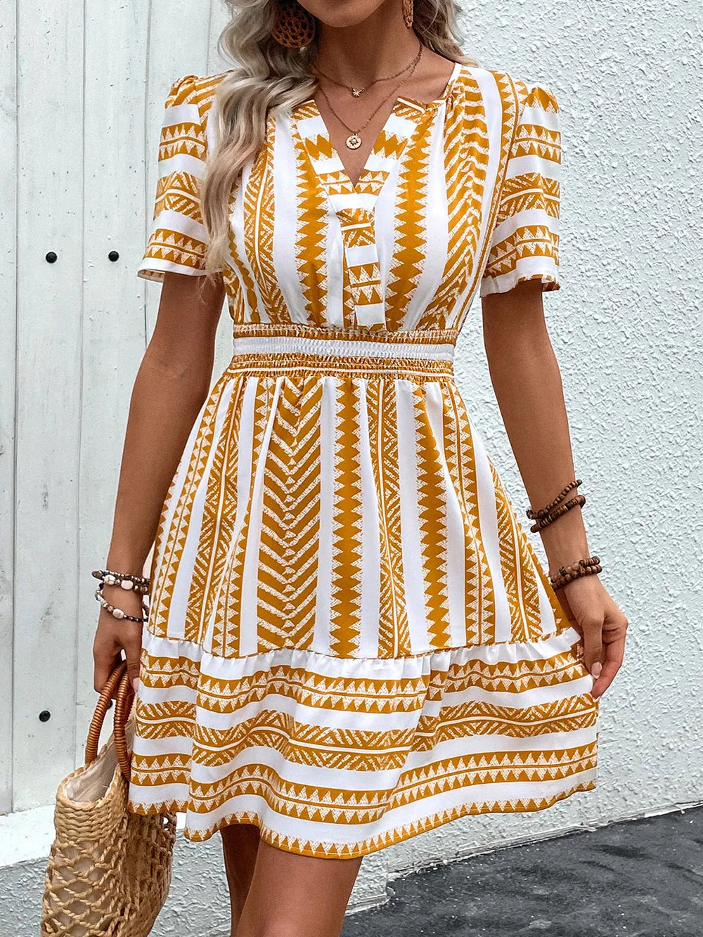 Plush Fashion Hub geometric notched short sleeve mini dress featuring a modern pattern and a fitted silhouette.