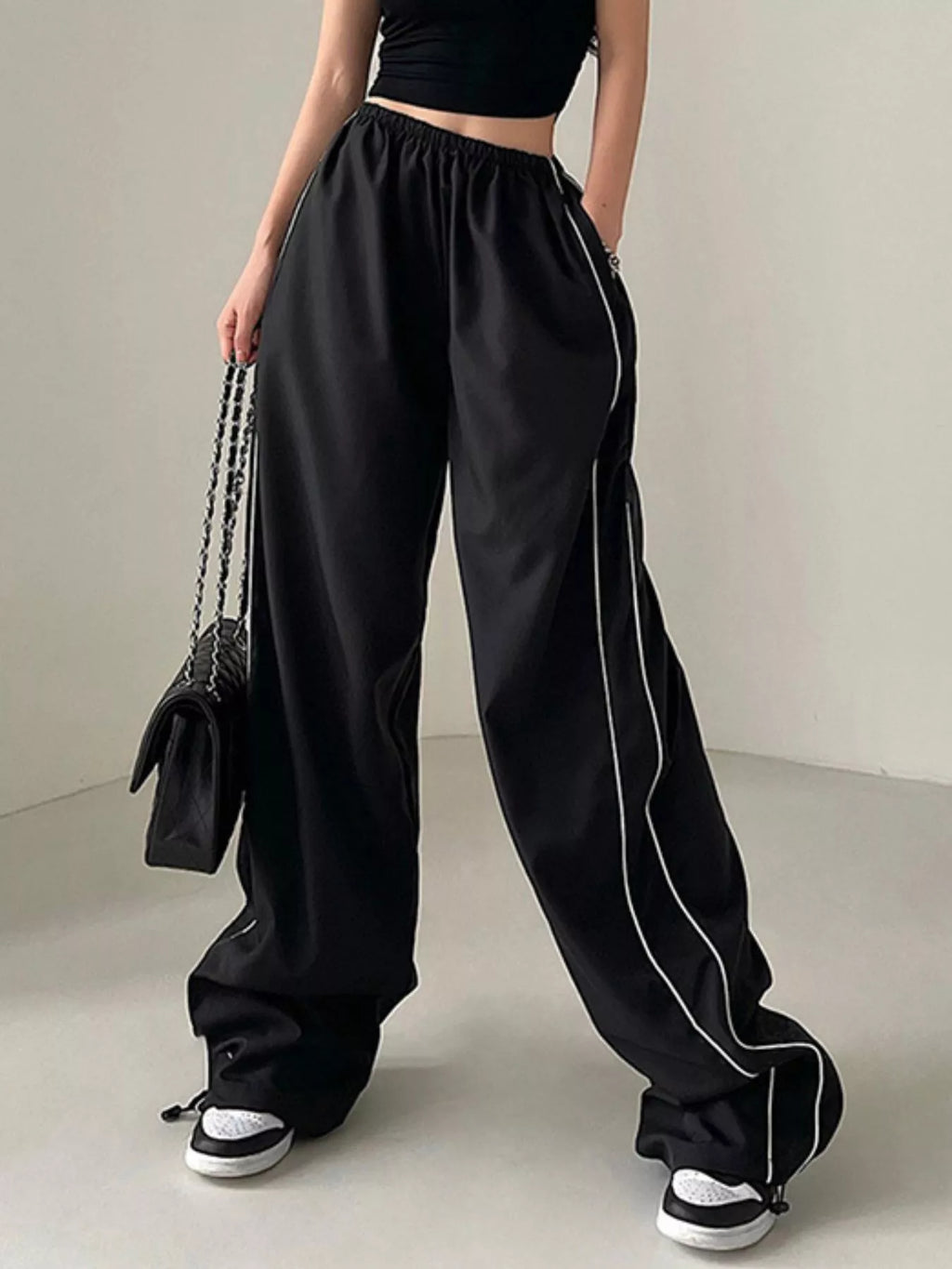 Women's high-rise wide-leg pants by Trendsi, lightweight elastic waist trousers, casual dress style with flowing fabric.