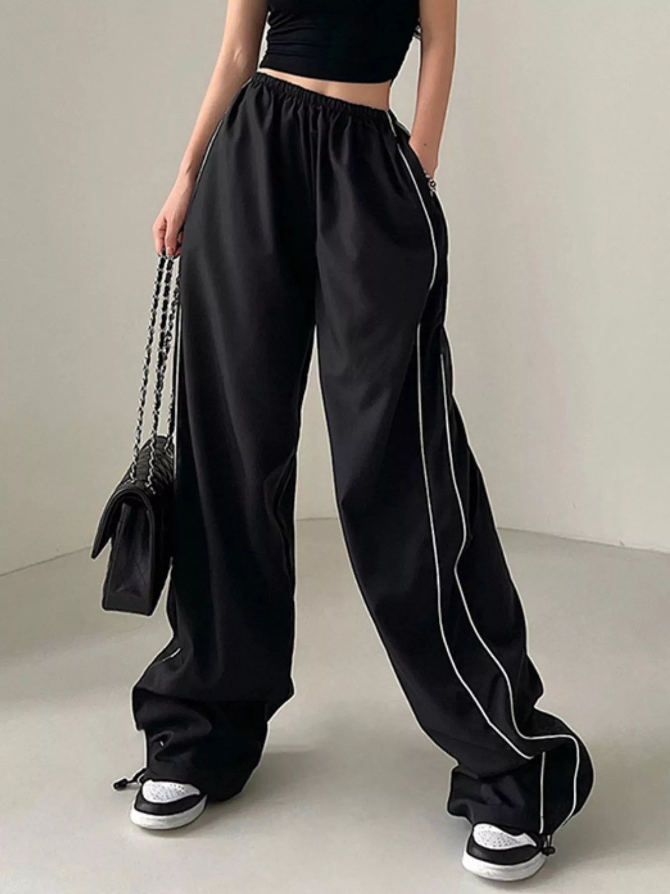 Women's high-rise wide-leg pants by Trendsi, lightweight elastic waist trousers, casual dress style with flowing fabric.