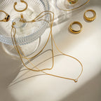 18K gold-plated layered necklace with delicate chains and small pendant, showcasing elegant jewelry design.