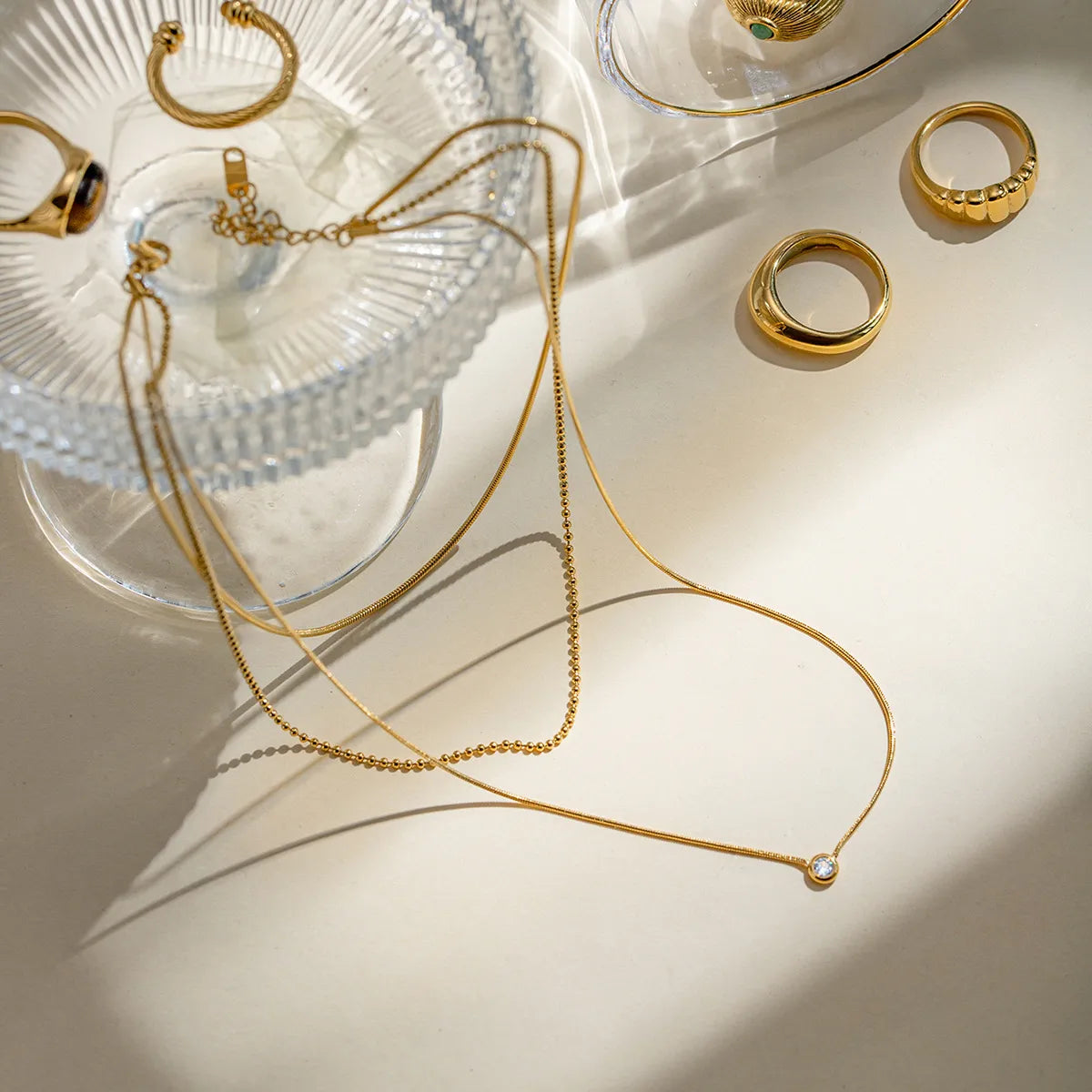 18K gold-plated layered necklace with delicate chains and small pendant, showcasing elegant jewelry design.