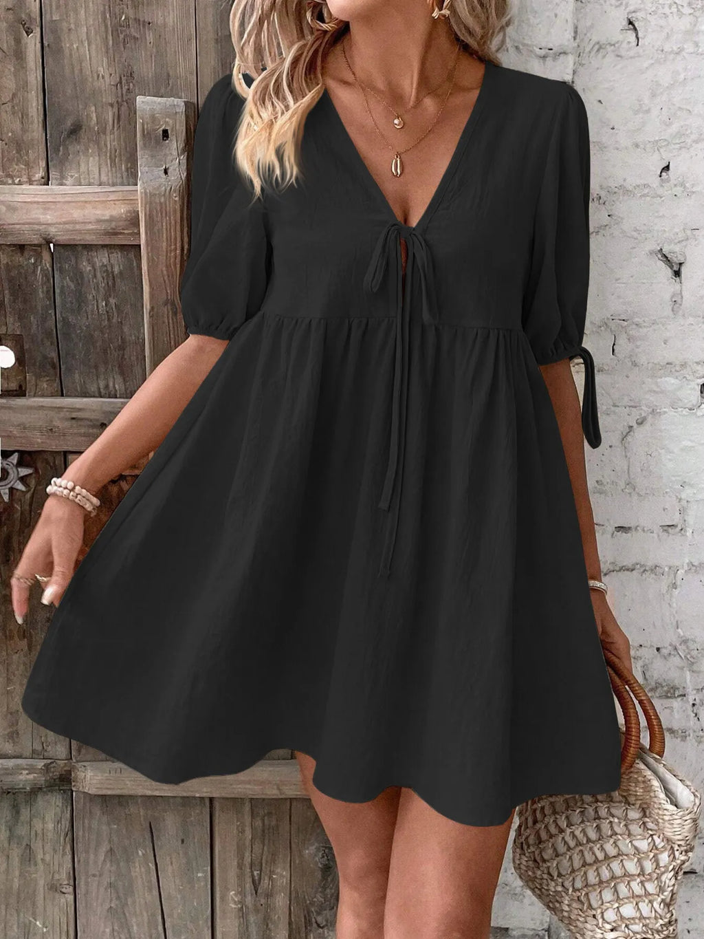 Cotton V-neck tie-front mini dress with puff sleeves, stylish and lightweight, perfect for casual or summer wear.