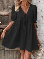 Cotton V-neck tie-front mini dress with puff sleeves, stylish and lightweight, perfect for casual or summer wear.