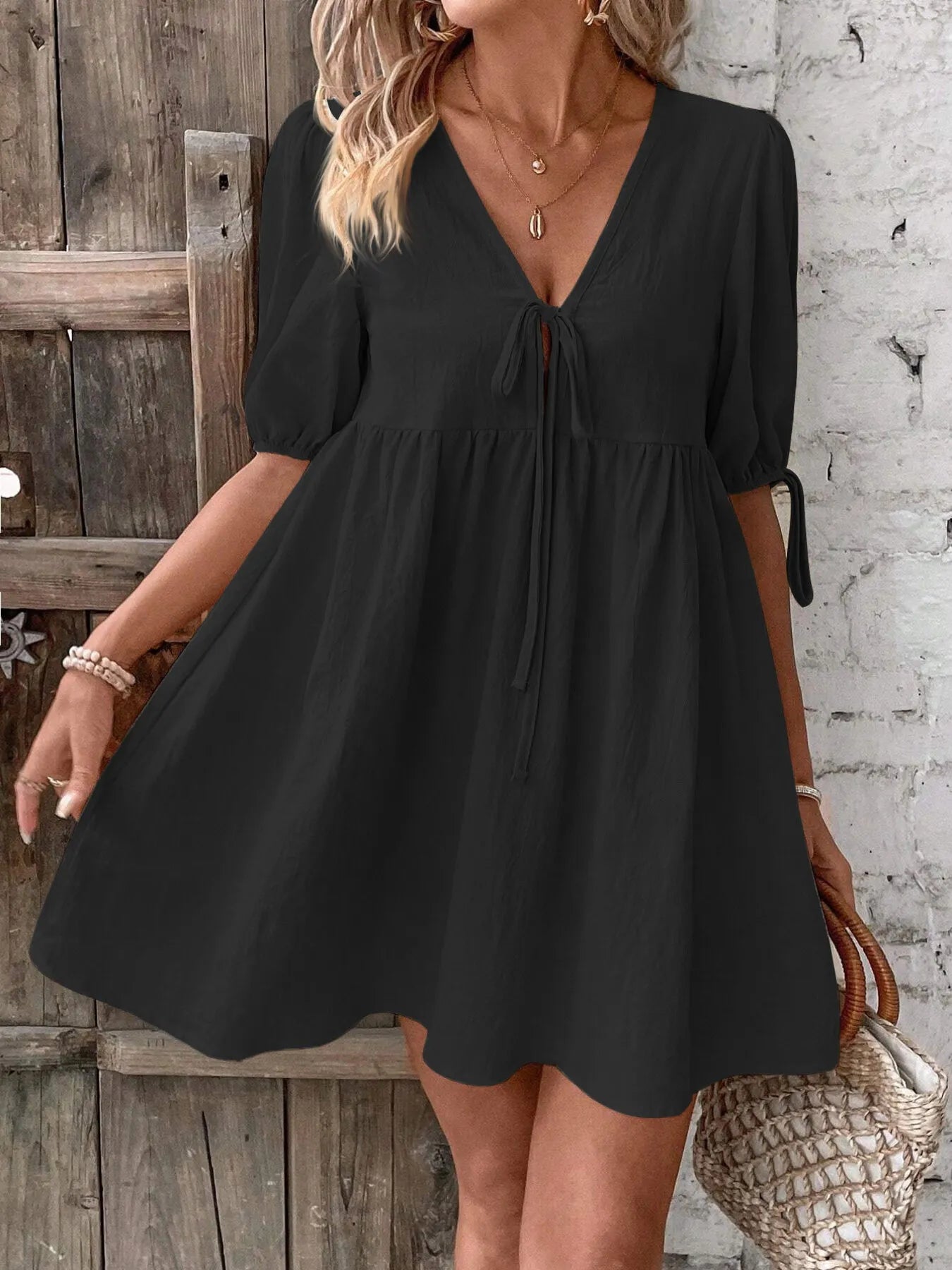 Cotton V-neck tie-front mini dress with puff sleeves, stylish and lightweight, perfect for casual or summer wear.