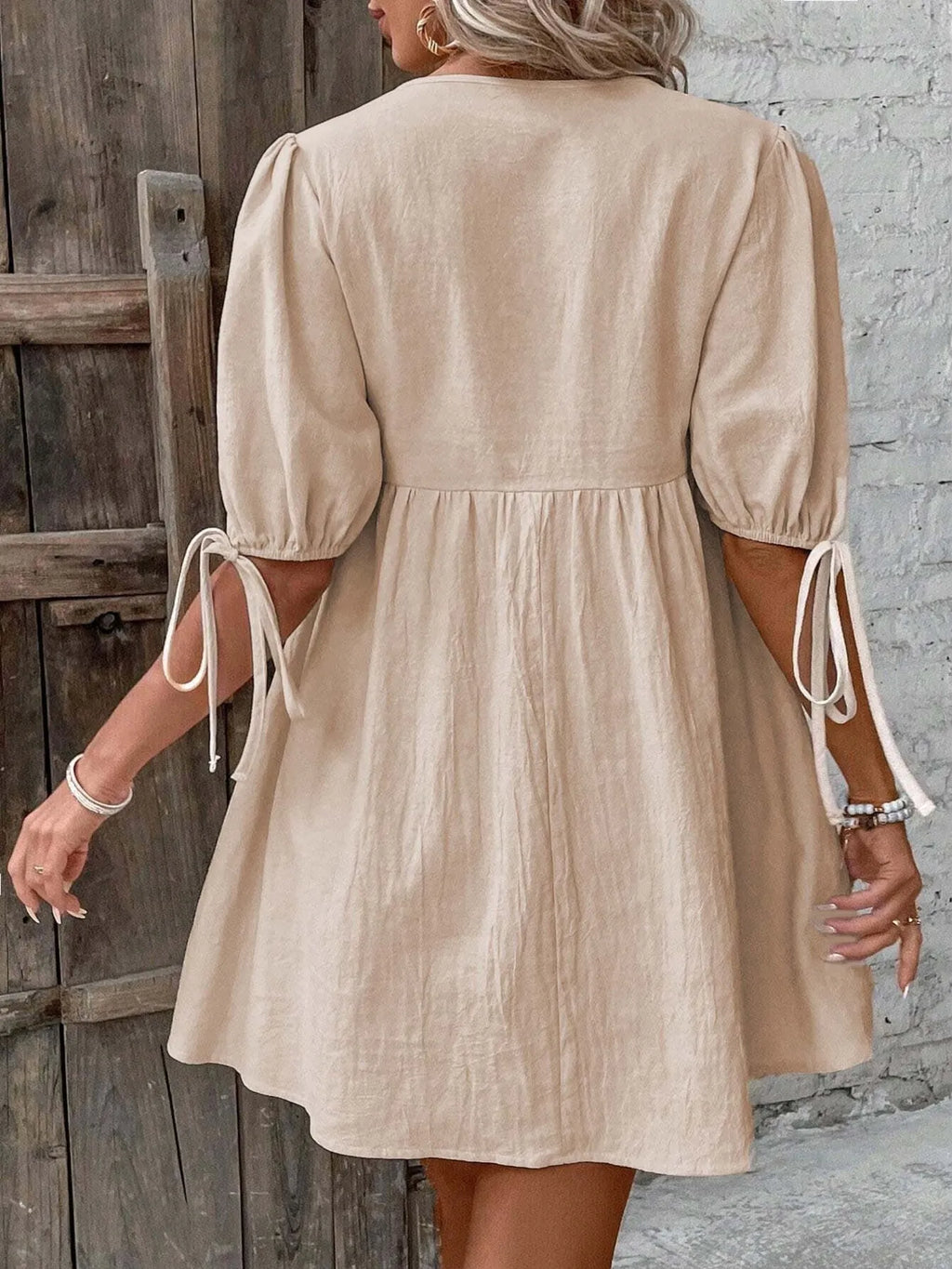 Cotton V-neck tie-front mini dress with puff sleeves, trendy and lightweight, perfect for casual or summer wear.