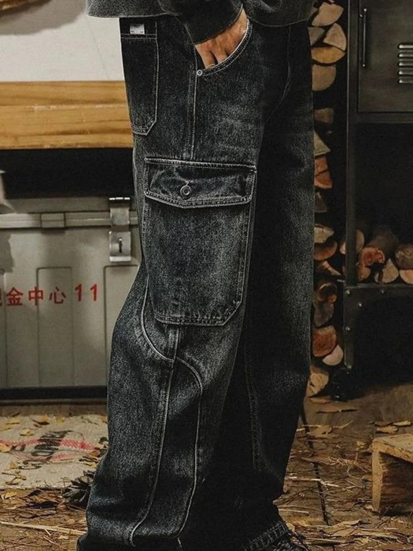 Men's washed wide leg cargo jeans by Trendsi, showing relaxed fit with multiple cargo pockets and distressed denim finish.