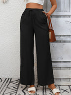 Women's high-waisted wide-leg drawstring pants in soft breathable viscose, shown in a relaxed fit with a comfortable waistband.