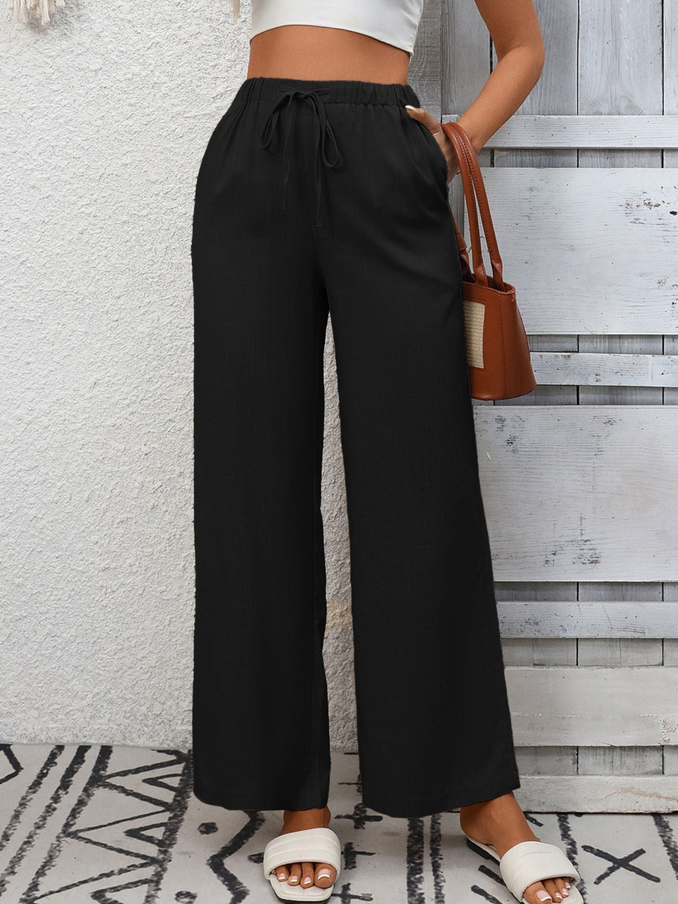 Women's high-waisted wide-leg drawstring pants in soft breathable viscose, shown in a relaxed fit with a comfortable waistband.