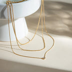 18K gold-plated layered necklace with delicate chains and small pendant, showcasing elegant jewelry design.