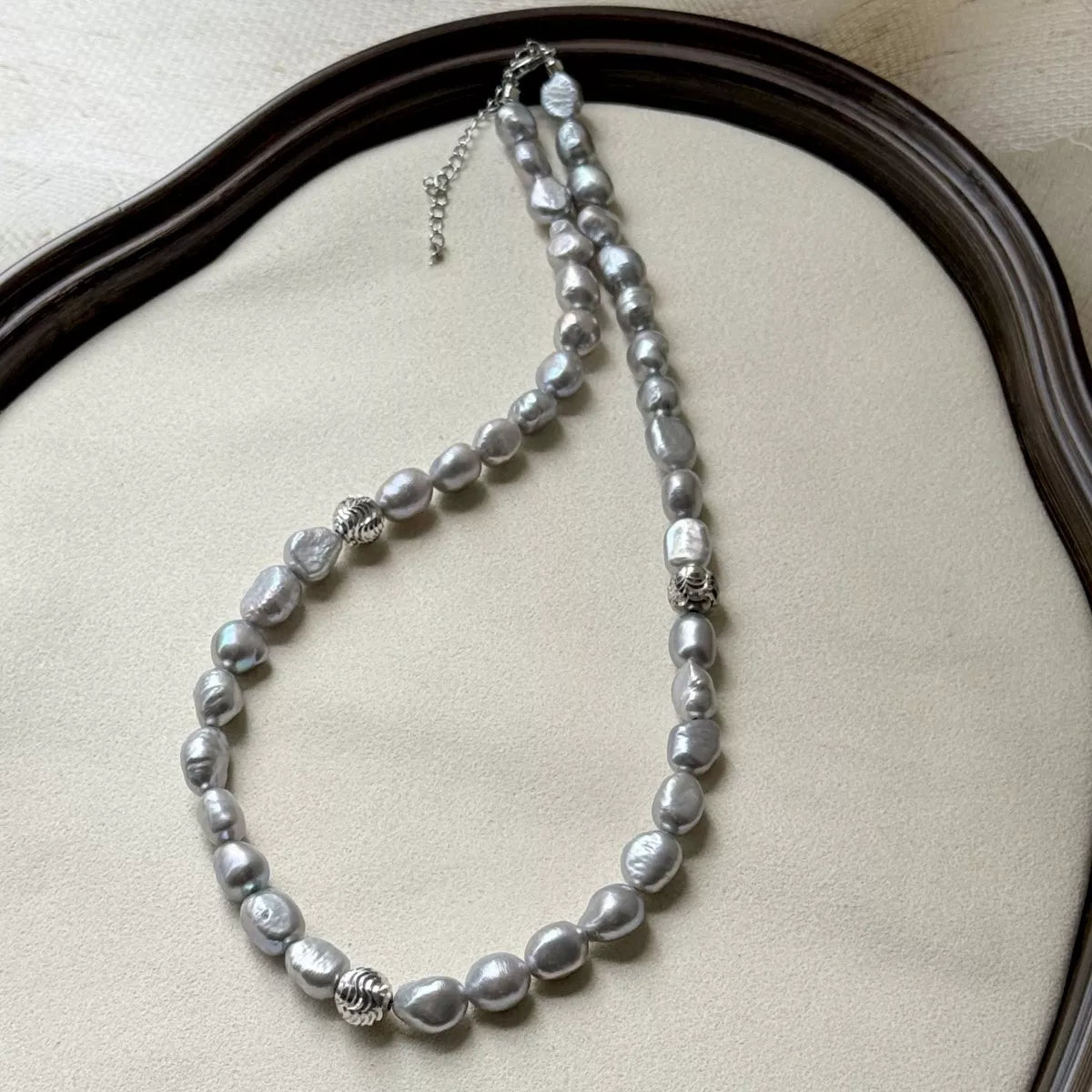 Pearl choker necklace by Shopimist featuring a string of white pearls on a delicate black cord.