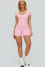 Fitglutes Activewear The Whisper Romper in black, fitted workout romper with sleeveless design and sporty style, on a model.