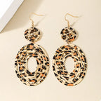 Leopard print dangle earrings by Shopimist featuring gold hooks and bold animal print design.