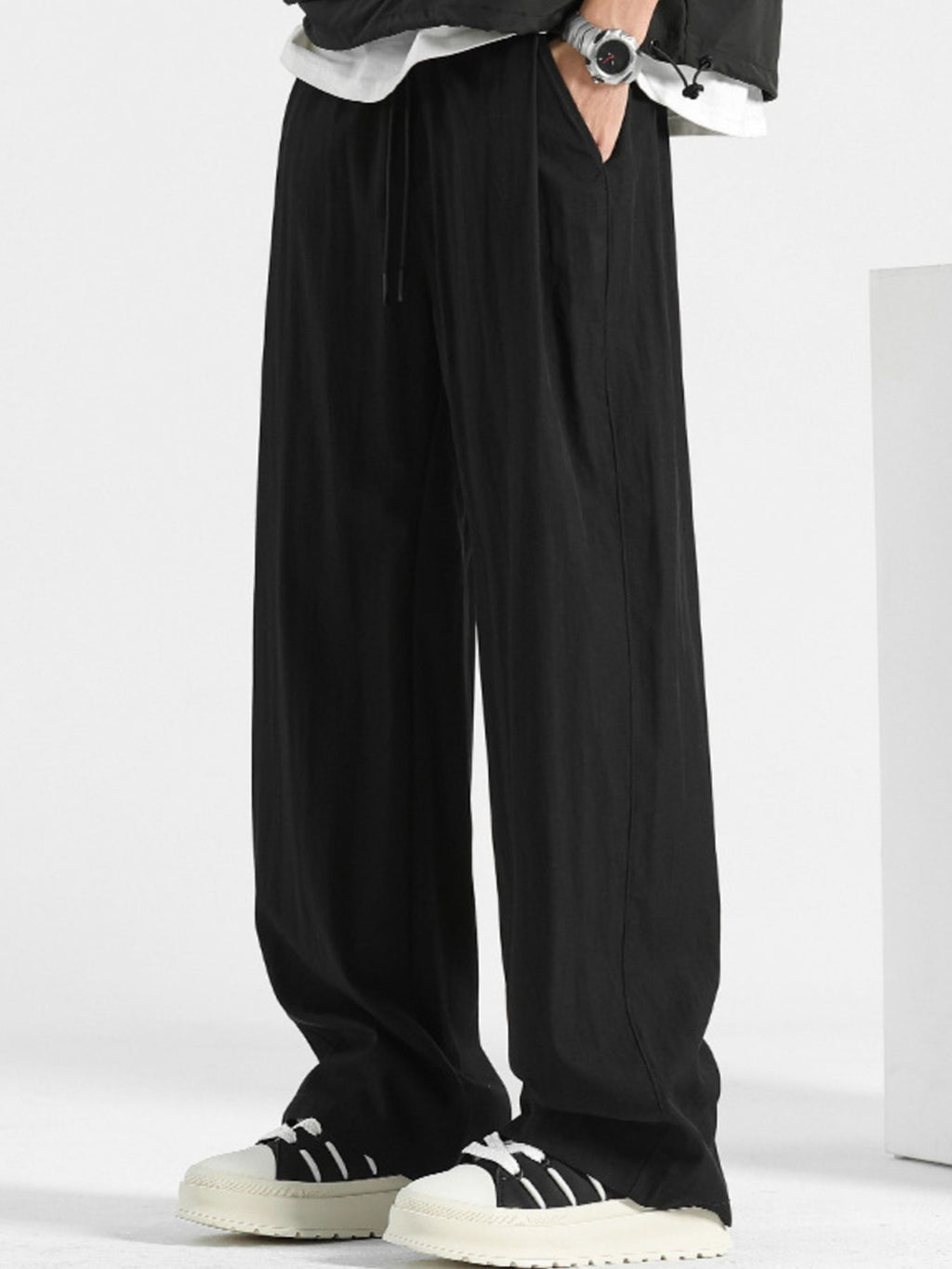 Men's loose fit casual pants with drawstring waist, relaxed fit, comfortable trousers by Trendsi, shown in a neutral fabric.