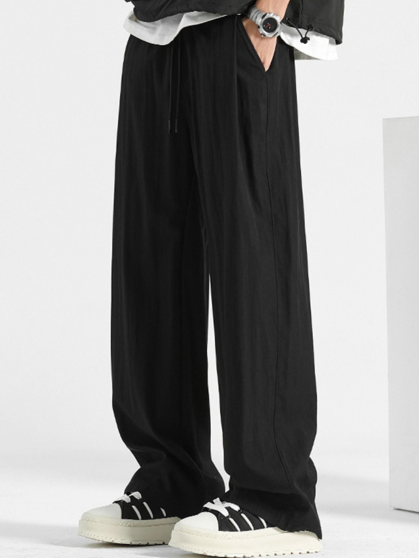 Men's loose fit casual pants with drawstring waist, relaxed fit, comfortable trousers by Trendsi, shown in a neutral fabric.