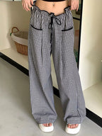 Women’s high-waisted gingham wide-leg pants with pockets, trendy fashion pants by Trendsi, shown in a stylish gingham pattern.