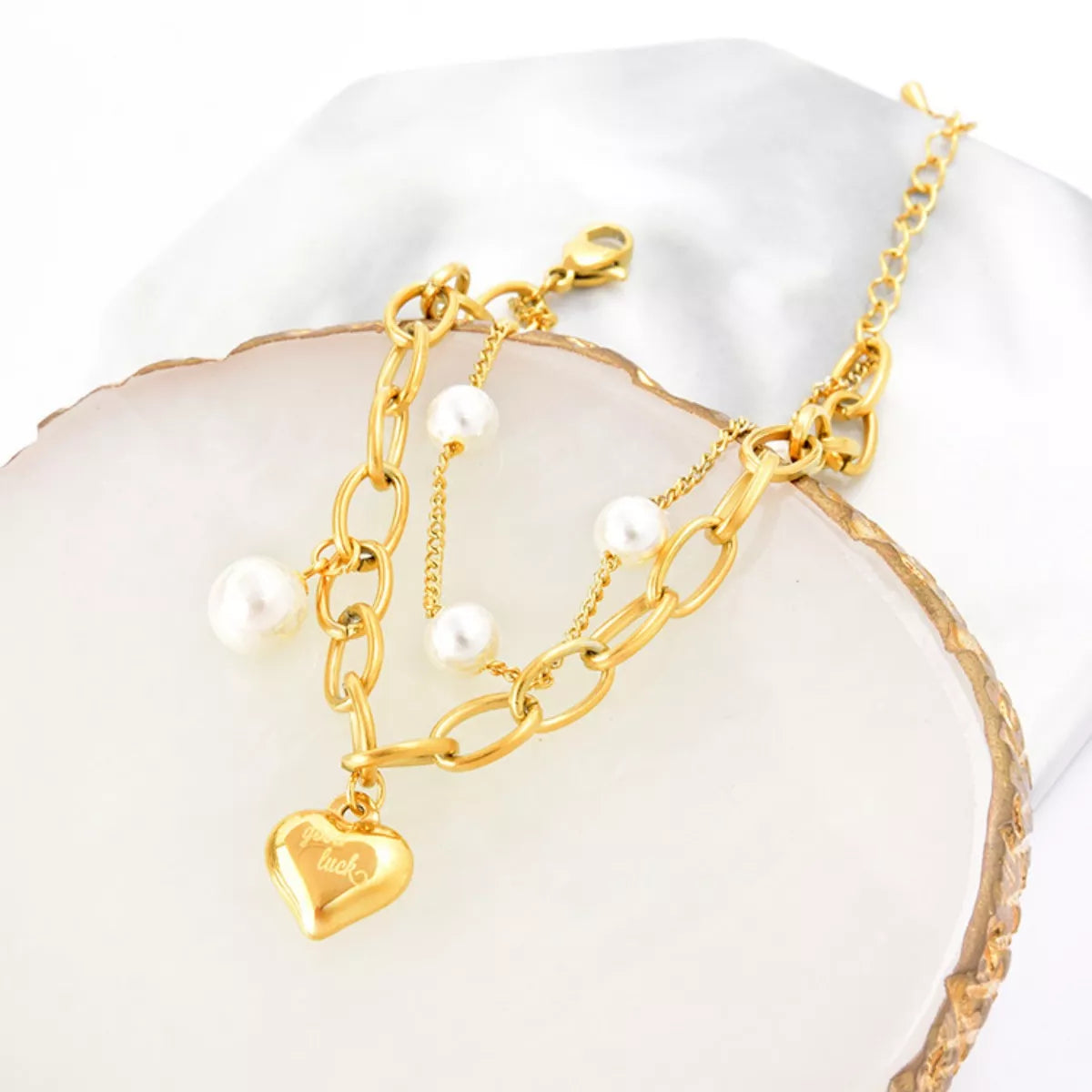 18K gold-plated heart charm bracelet with delicate chain and small heart pendants, showcasing elegant jewelry design.