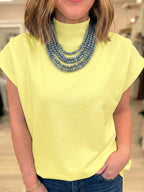 Women's mock neck cap sleeve blouse by Trendsi, stylish stretchy office top with elegant design and versatile look.