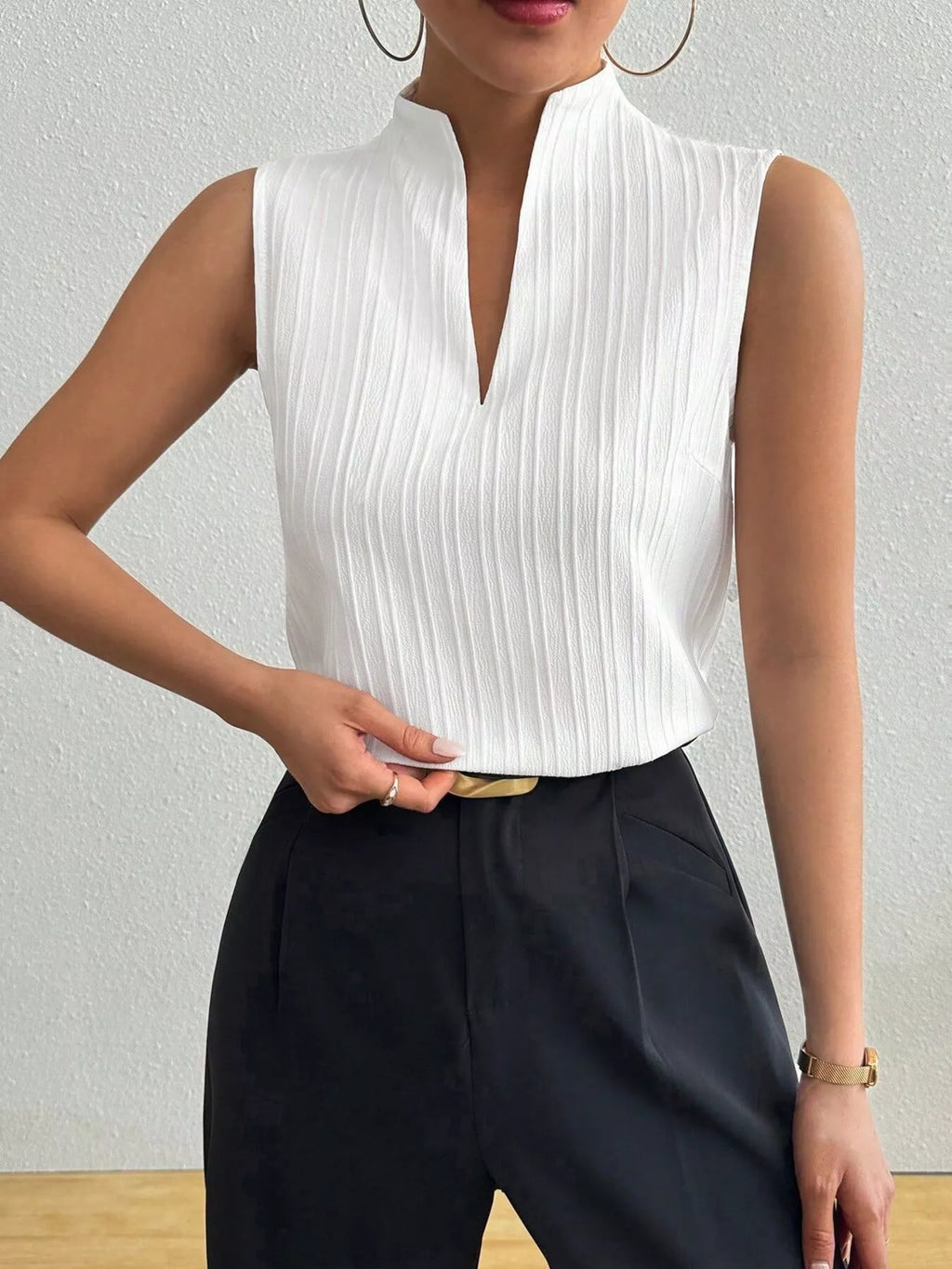 Women’s textured sleeveless tank top with notched neckline, versatile basic shell by Trendsi, shown in a close-up view.