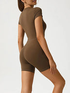 Trendsi half zip short sleeve active romper in lightweight fabric, featuring a sporty design with a zipper front and casual fit.