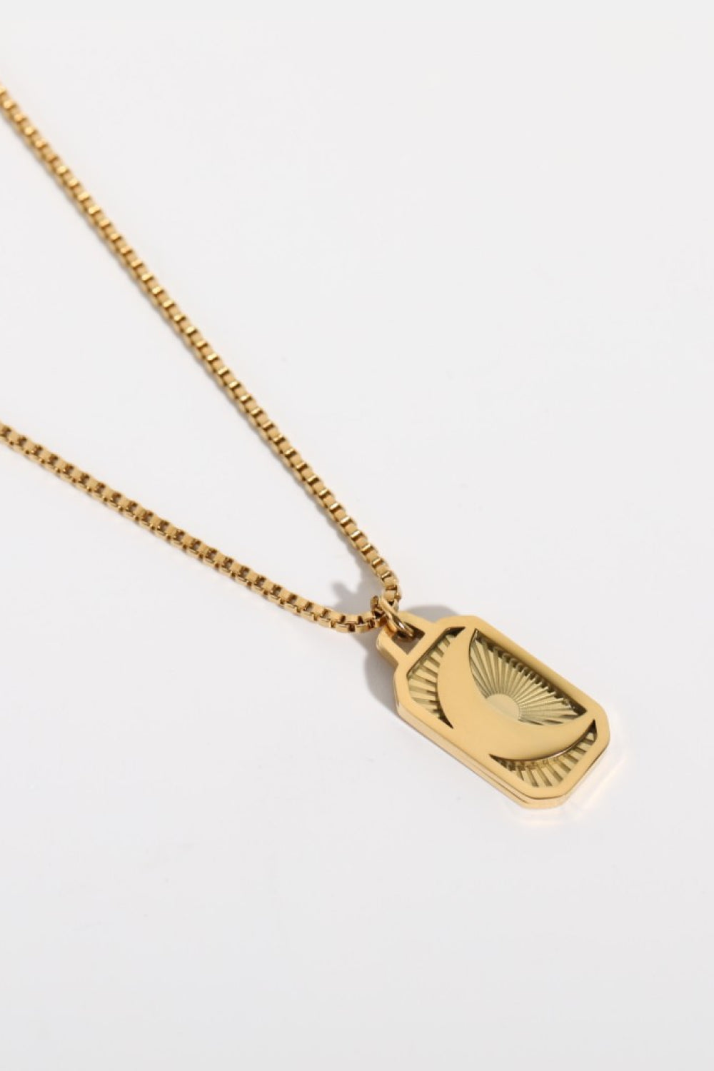 Stainless steel 18K gold-plated necklace with a delicate chain and pendant, displayed on a neutral background.