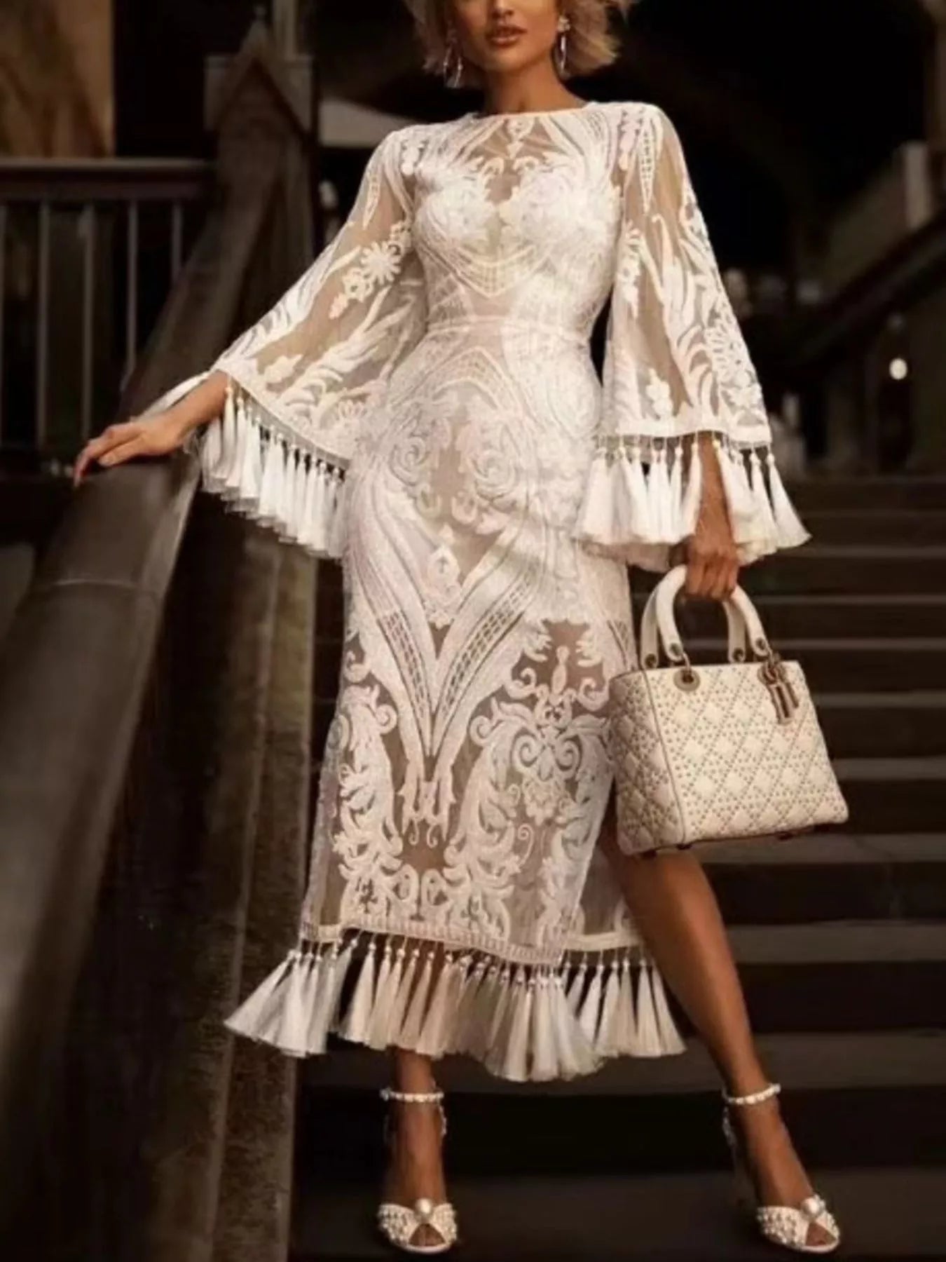Plus size lace flare sleeve dress with tassel hem by Plush Fashion Hub, featuring elegant lace fabric and flowing design.