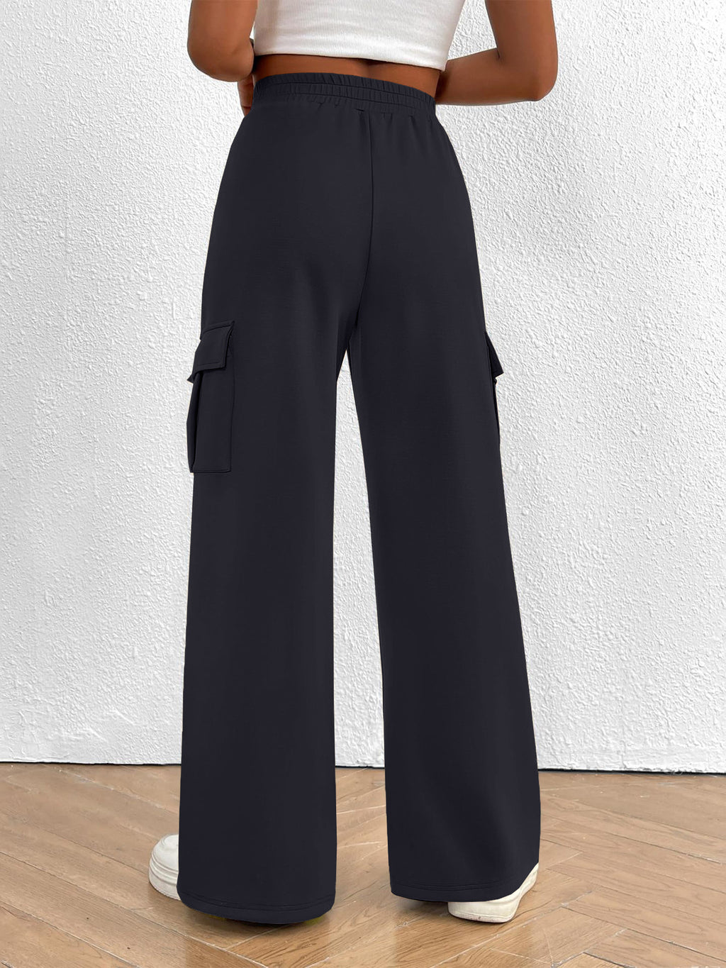 Lightweight women's high-waisted casual cargo pants with drawstring waist, featuring utility-style design and multiple pockets.