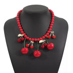 Cherry Charm beaded statement necklace featuring vibrant red cherry charms and intricate beadwork by Shopimist.