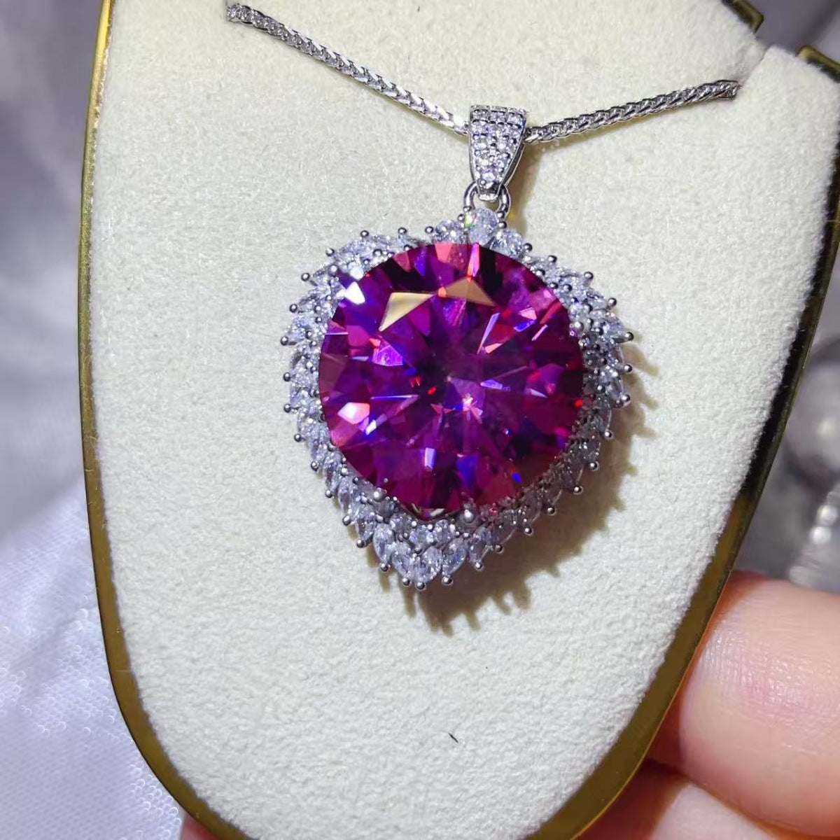 Sterling silver moissanite pendant necklace with a 20-carat gemstone, featuring a sleek and elegant design.