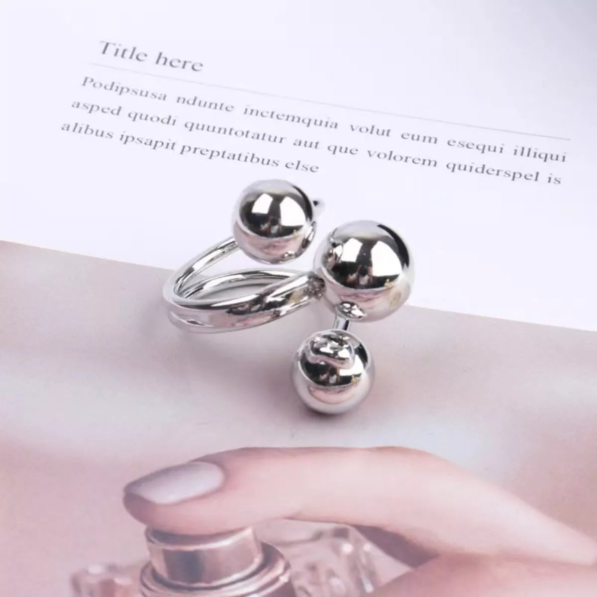 Multi-layered ball ring by Shopimist featuring stacked silver bands with textured ball accents.