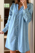 VYSN button-up notched long sleeve denim dress hanging on a rack, showcasing classic denim fabric and stylish design.