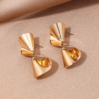 18K gold-plated twist earrings with a sleek, modern design, featuring a shiny finish and elegant hoop style.