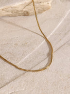 18K gold-plated three-layered cross necklace with intricate details, layered design, and chain links, showcasing elegance and craftsmanship.