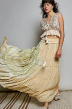 Shopimist POL Shimmer Tiered Reverse Ruffle Maxi Skirt with smocked waist and shimmering fabric, styled with flowing layers.