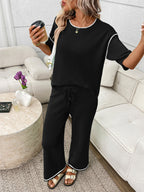 Women's casual two-piece lounge set with round neck top and drawstring pants by Trendsi, shown in a comfortable, relaxed fit.