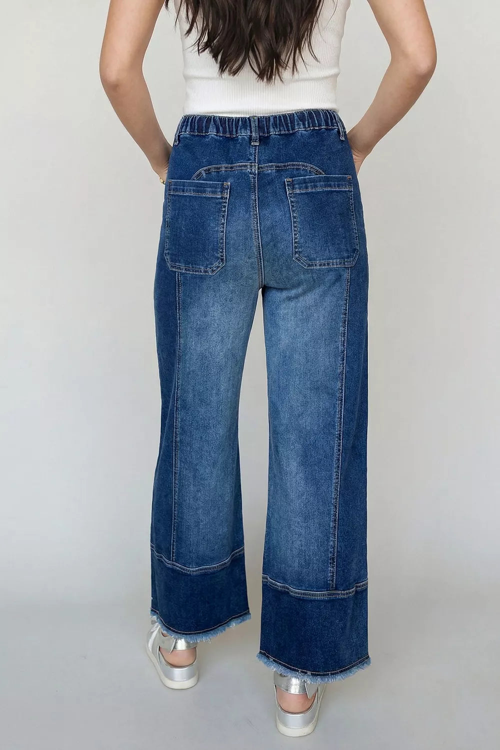 Wide-leg denim pants with drawstring waist, seam details, raw hem, and a relaxed fit from Plush Fashion Hub.