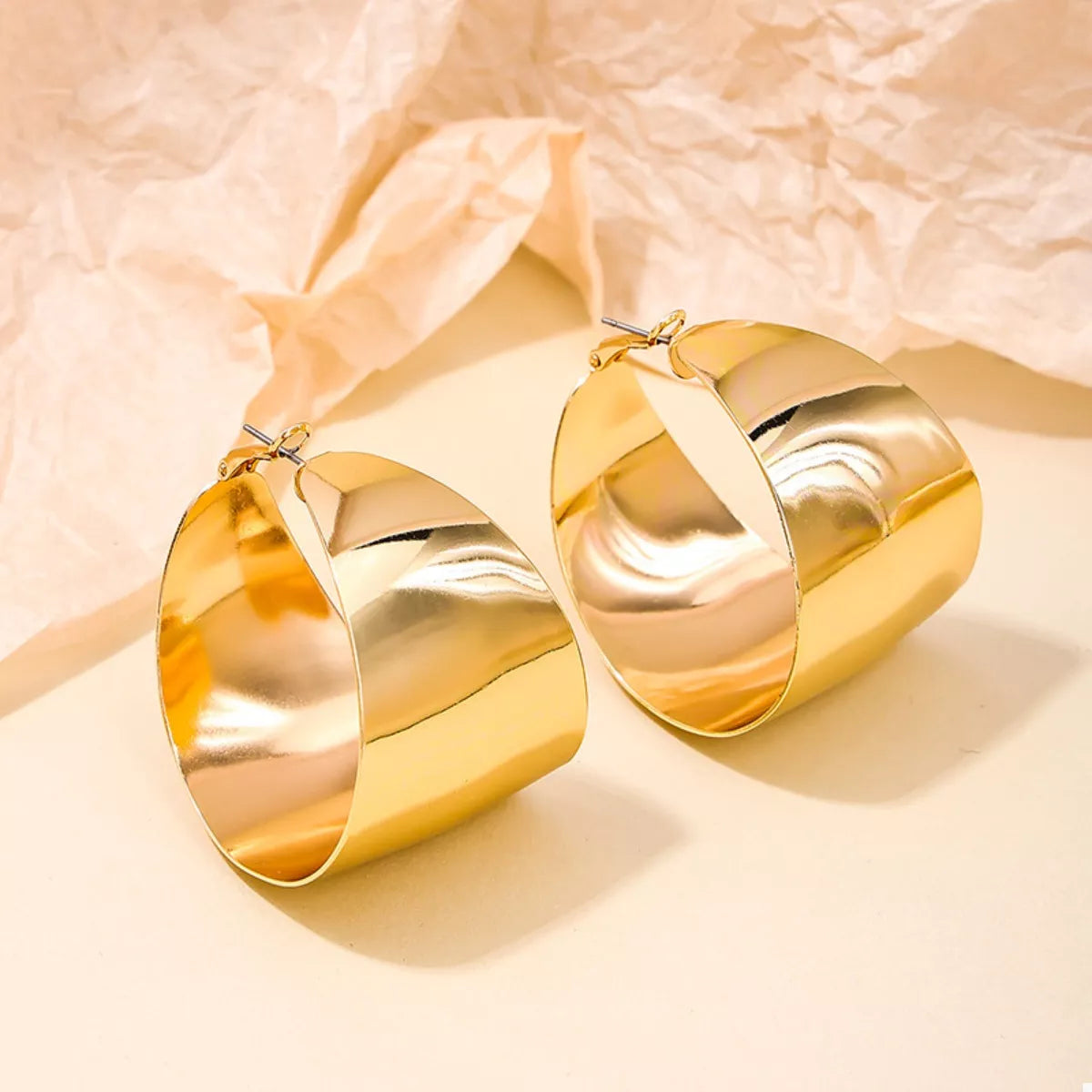 Plush Fashion Hub alloy wide hoop earrings with a shiny gold finish, showcasing their large circular design and smooth surface.