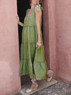 Women's cotton tiered frill V-neck sleeveless summer dress by Trendsi, featuring a flowy silhouette and feminine ruffle details.