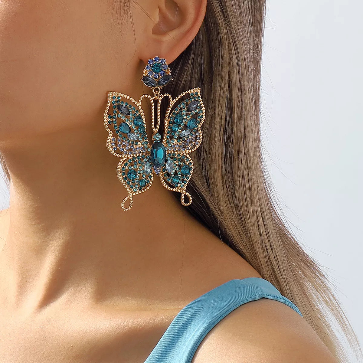 Shimmering butterfly rhinestone dangle earrings with intricate details, perfect for stylish fashion accessories.