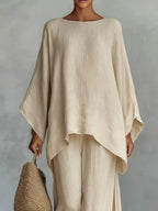 Plus size full size round neck top and wide leg pants set by Trendsi, featuring a comfortable fit and stylish design.