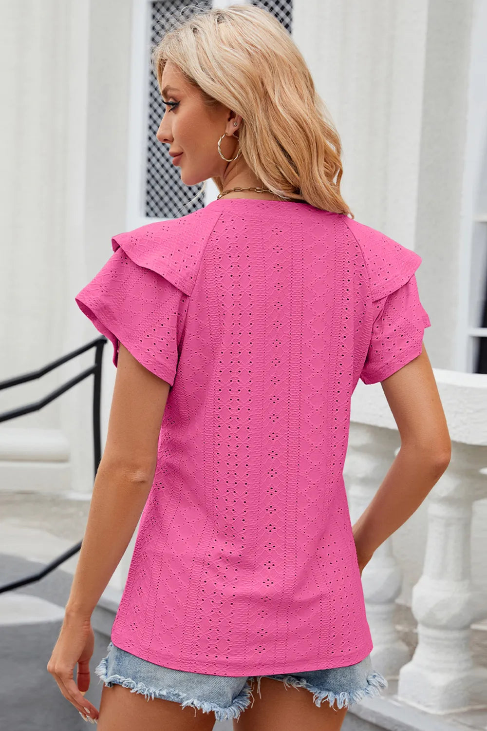 Light blue Eyelet Notched Flutter Sleeve T-Shirt from Trendsi featuring flutter sleeves and eyelet detailing, close-up view of the top.