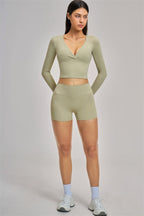 Fitglutes Activewear long sleeve crop top with fitted design, shown on a model, ideal for gym and workout sessions.