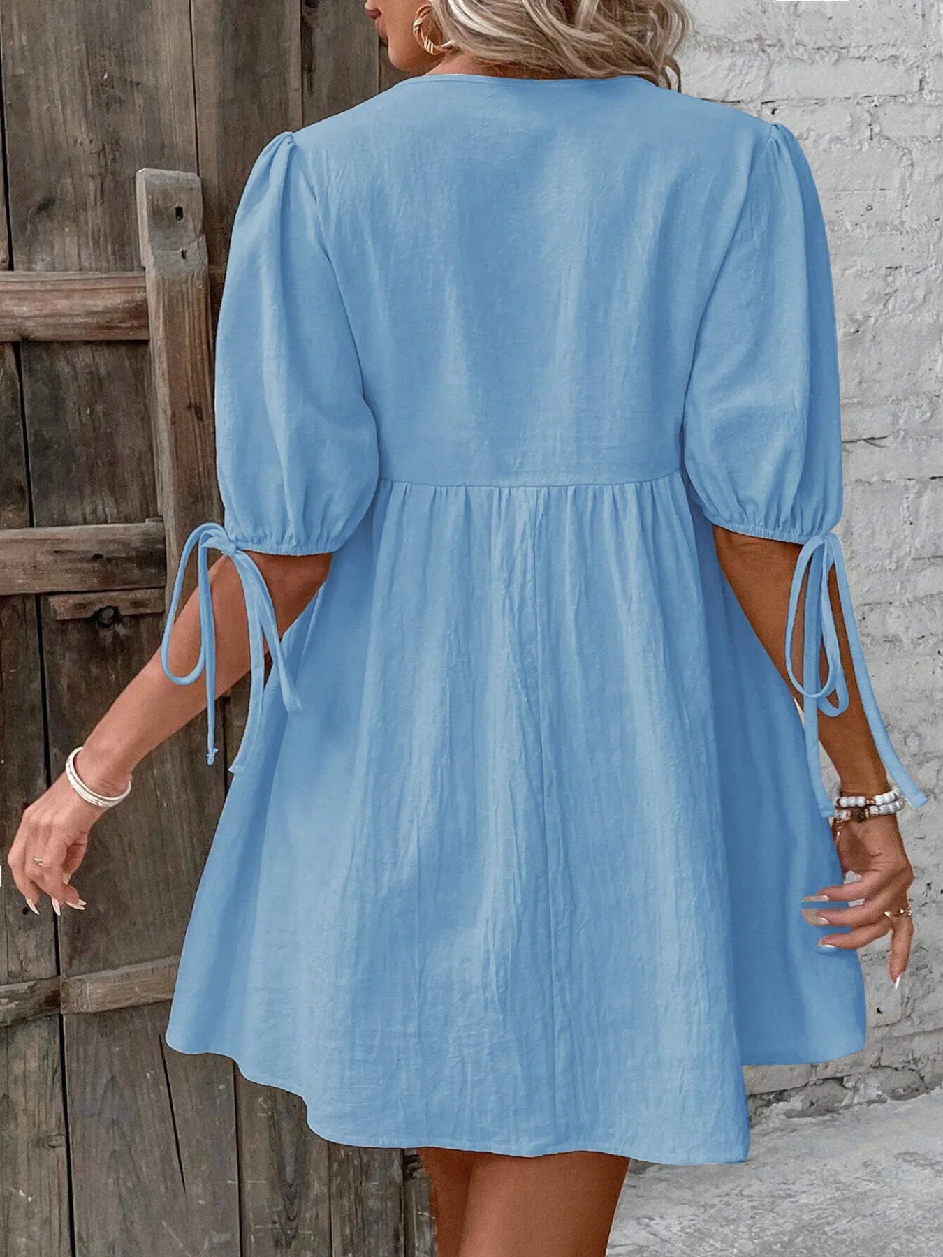 Cotton V-neck tie-front mini dress with puff sleeves, stylish and comfortable, perfect for casual or summer wear.