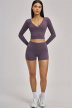 Fitglutes Activewear long sleeve crop top with fitted design, shown in black, perfect for gym and workout sessions.