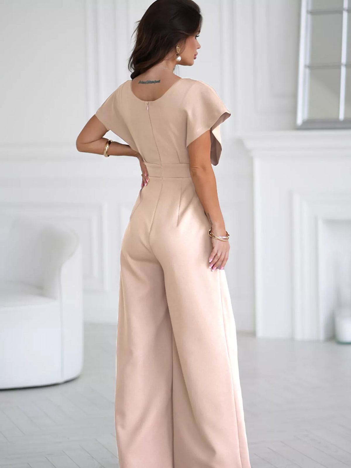 Plush Fashion Hub surplice wide-leg jumpsuit displayed on a hanger, featuring a comfortable, stylish design with soft fabric.