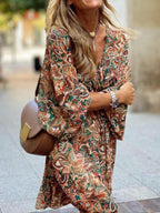 Plush Fashion Hub paisley print balloon sleeve mini dress with boho style, featuring a flowy silhouette and vibrant pattern.