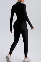 Trendsi half zip mock neck active jumpsuit in black, form-fitting athletic wear with long sleeves and a sleek design.